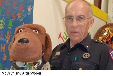 Artie Woods and McGruff, crime dog, teach how to take a bite out of crime